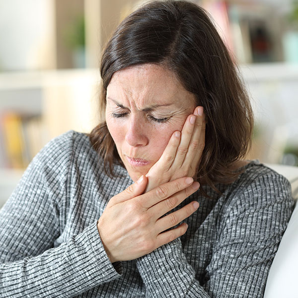 Woman experiencing a dental emergency