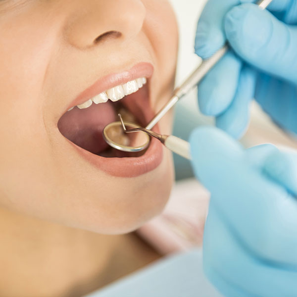 Woman receiving a tooth extraction